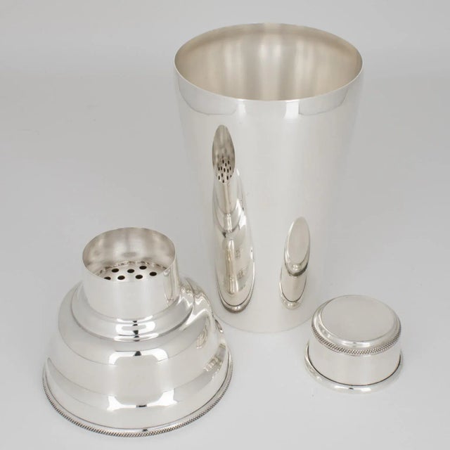 Silversmith Asprey, London, designed this stunning Art Deco silver plate cocktail or Martini shaker. The cylindrical piece...