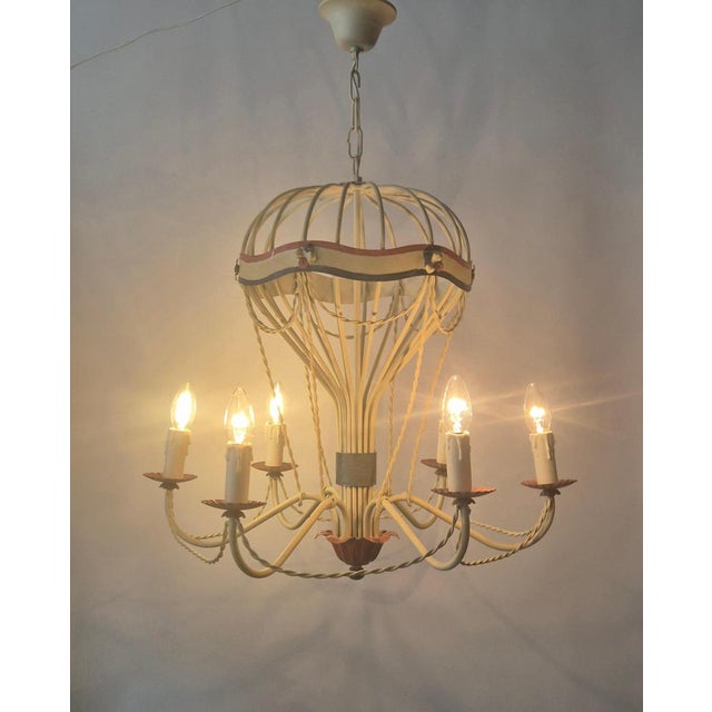 Chandelier in the shape of a hot air balloon, mid-20th century. A whimsical structure with arched metal rods forming an...