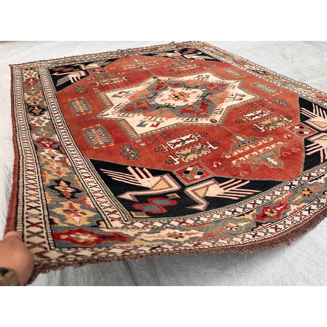 This antique hand-knotted Chelaberd (Eagle Kazak) rug from the Karabagh region features a bold sunburst star medallion in...