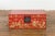 A small Chinese red lacquered wedding blanket chest from the 20th century, with gilt décor depicting guardian lions,...