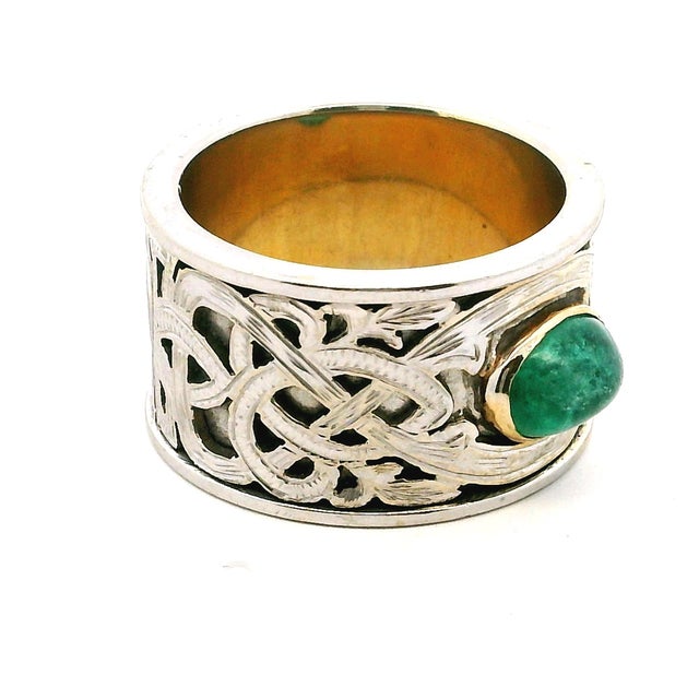 Vintage statement ring crafted in 14 karat white gold and centered with a natural emerald cabochon measuring approximately...