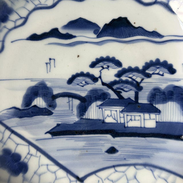 Elegant Japanese sometsuke plate (underglaze cobalt blue) with a serene central landscape: a waterside pavilion, pines,...
