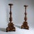 A pair of large altar candlesticks made of carved wood, partly with a gold patina and partly with a porphyry look, on a...