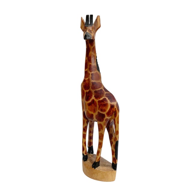 Elevate your home decor with the exquisite Kenyan Wooden Carved Giraffe Figurine, a stunning representation of...