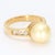 Here is a nice classic style 18k yellow gold ring with diamond accents flanking a central yellow pearl. - Stone Info - 1x...
