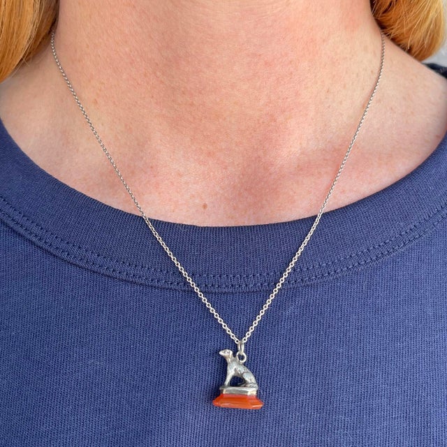 This enchanting fob is a miniature masterpiece of 18th-century French craftsmanship. A delicately sculpted silver dog,...