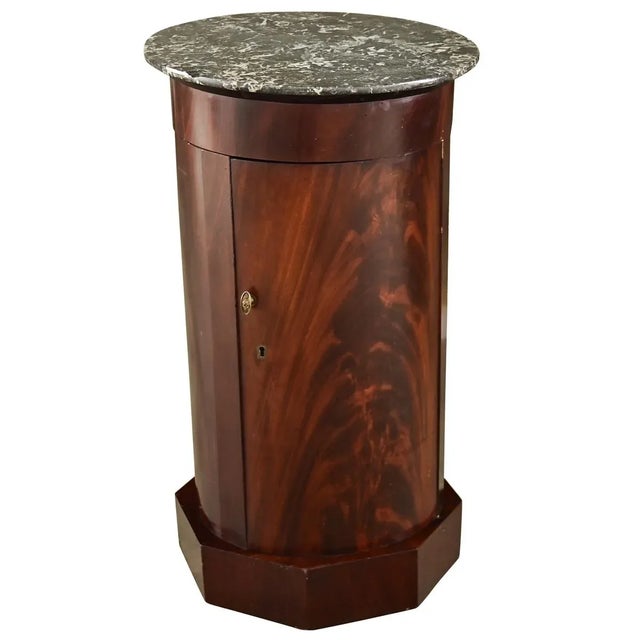 A columnar, English mahogany and marble top bedside table that offers both storage and display to fit in any room around...