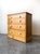 A beautiful 19th-century English pine chest featuring a warm, waxed finish, with crisp white porcelain knobs. This piece...
