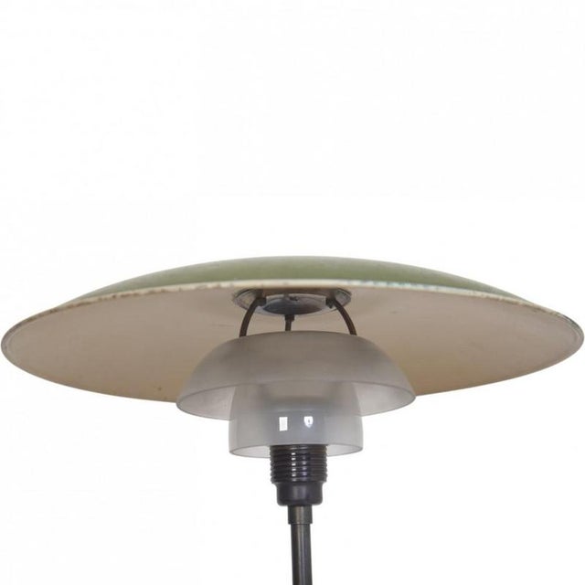 Poul henningsen ph4½/3 table lamp with an upper shade of green metal, under shades of matt opal glass, and a frame of...