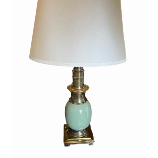 Iconic midcentury ostrich egg lamp by Stiffel. Lamp has a heavy, beveled brass base. The "egg" is made of china in a muted...