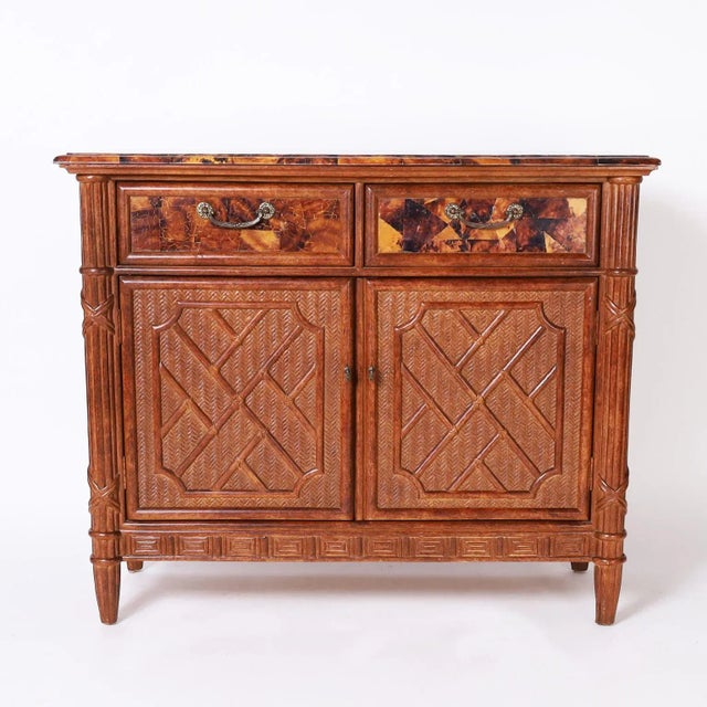 Dynamic mid century cabinet with a pen shell mosaic beveled top over a case with two pen shell covered drawers, two...