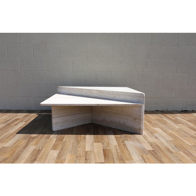 Spectacular Italian two-piece travertine coffee table dating from the 1970s, featuring a striking geometric triangular...