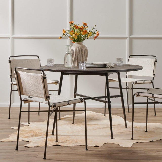 Slim lines meet mixed materials for style and comfort alike. Finished in a waxed black, architecturally inspired iron...