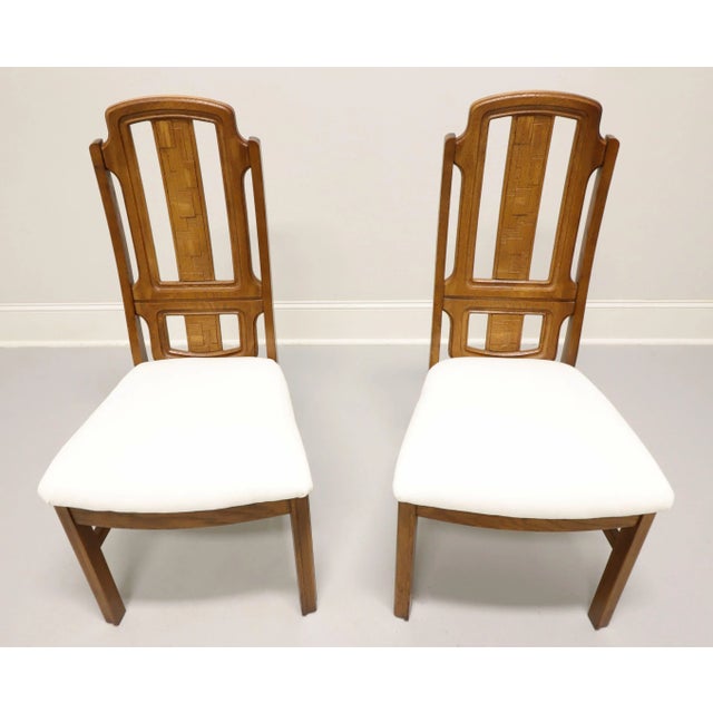 A pair of Mid 20th Century Brutalist style dining side chairs by Broyhill Premier. Oak with slightly distressed finish,...