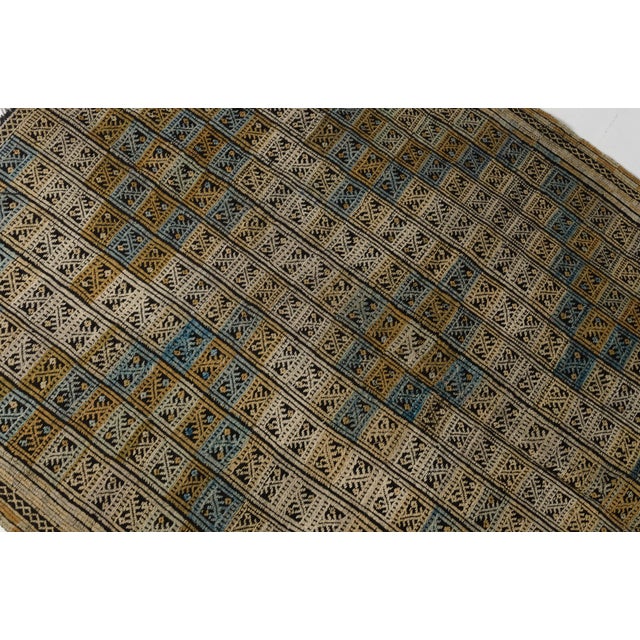 This is a vintage Turkish Oushak rug from the Mid 20th Century. The piece was hand-knotted.