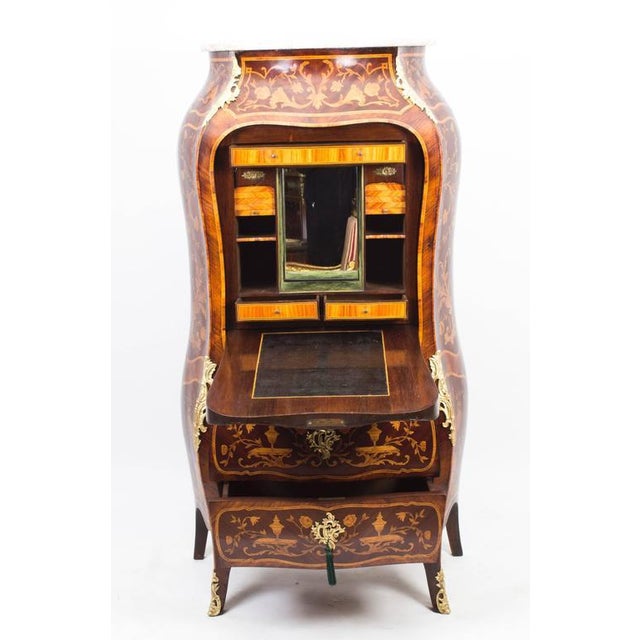 Dating from around 1850, this is a wonderful antique French Rococo Revival Secretaire a Abattant featuring ormolu mounted...