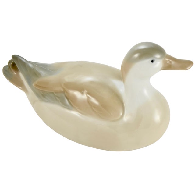 Porcelain duck with detailed feather texture in soft shades of gray, tan, beige, black and white. No maker's mark.