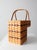 A classic vintage splint weave stair basket crafted in warm honey-toned wood with a traditional stepped silhouette...