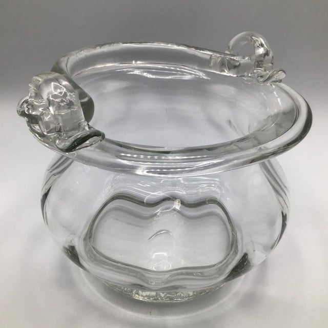 Beautiful hand blown glass basket bowl with handle that can lay flat or upright. When handle is up it measures 9 inches...