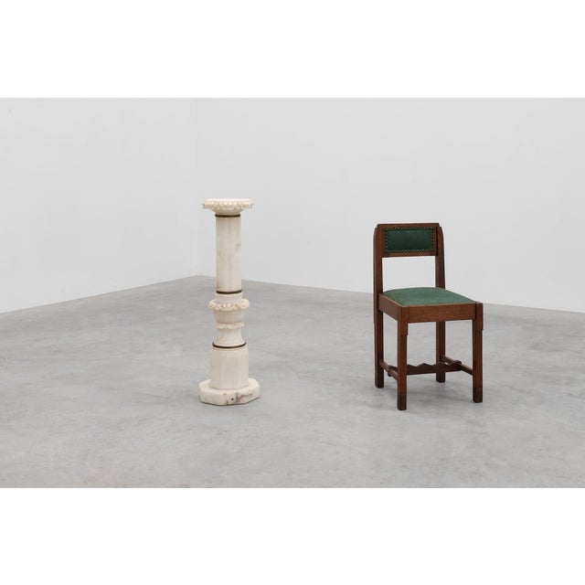 An elegant Italian marble pedestal column from around 1900, finely carved from white marble with subtle natural veining....