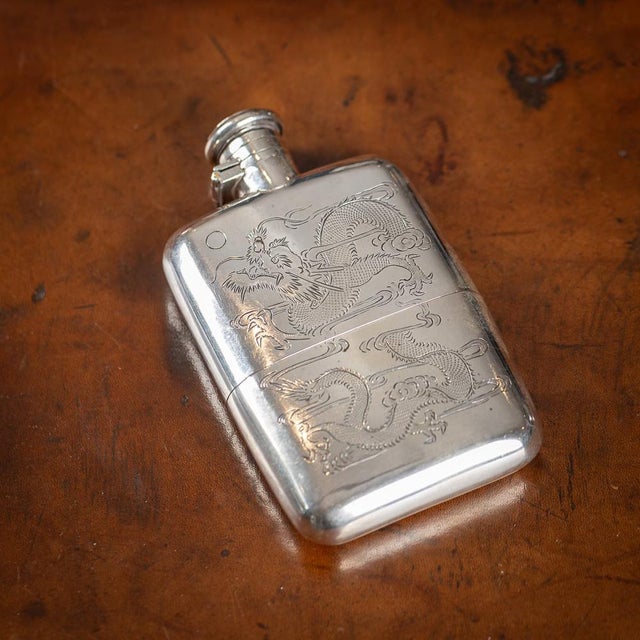 A stunning early 20th Century Chinese Export solid silver hip flask with silver hinged top and removable cup. This flask...