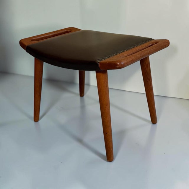 Elegant Danish Mid-Century Modern stool dating from the 1960s, crafted in teak and featuring a distinctive sculptural...