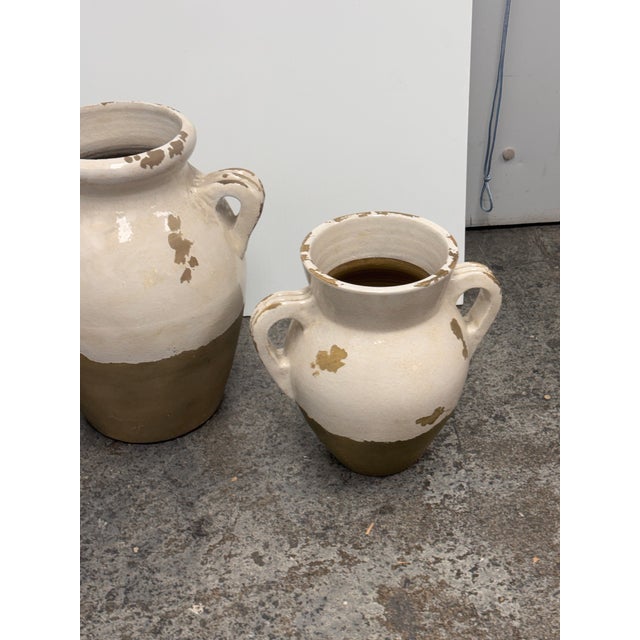 Design Plus Gallery presents a Set of Three Tuscan Terracotta Double-Handled Urns from Pottery Barn. This coordinating set...