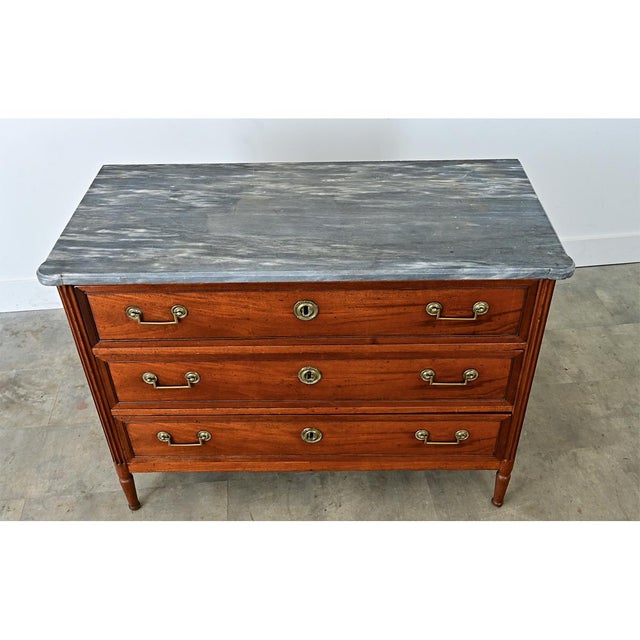 A gorgeous Louis XVI-style commode with a grey marble top. The original stone top has stunning, streaky white veining and...