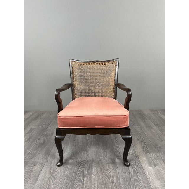 Pair of stained wood armchairs, resting on cabriole legs ending in deer feet. The caned backs, in good condition, lend...