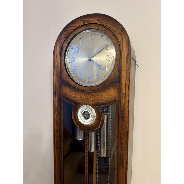 Unusual quality antique oak chiming longcase barometer clock, having a quality antique oak cased long case clock with...