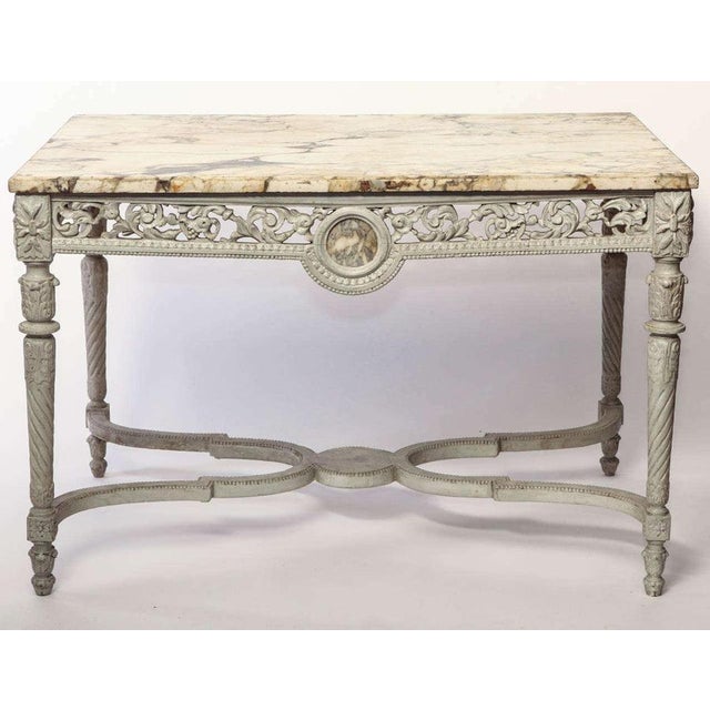 A fine French 19th century finely carved and ivory painted centre table with breche marble top.