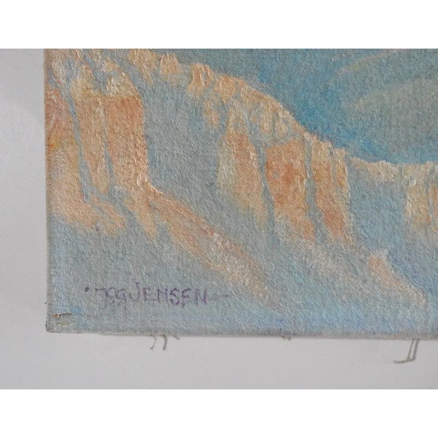 Late 20th century oil on canvas painting of the Grand Canyon with eagle flying in pale blue and peach. Signed Jensen lower...