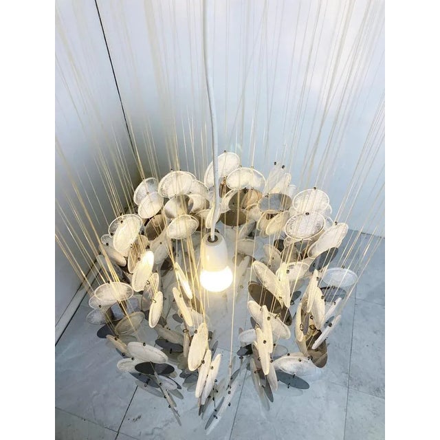 Spectacular chandelier with lots of smoked and white Italian glass discs. Most of these chandeliers where made with mother...