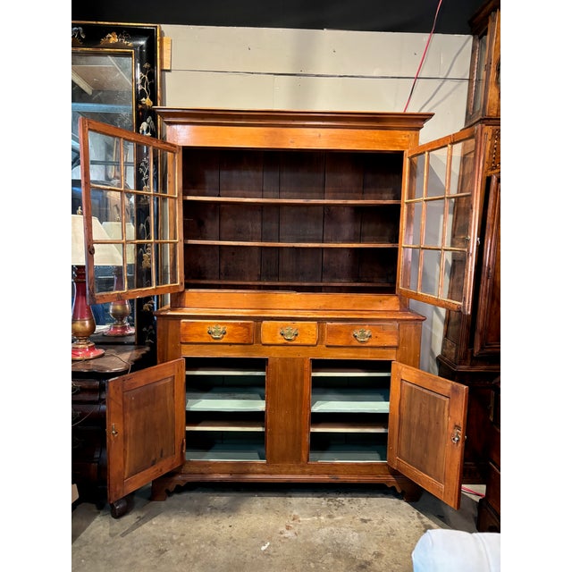 A two-piece design, with the top section sitting back from the base to create a counter space. These cupboards were...