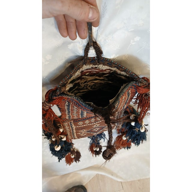 An antique Baluch tribal salt bag (namakdan), handwoven by nomadic weavers in the Baluchistan region of Afghanistan or...