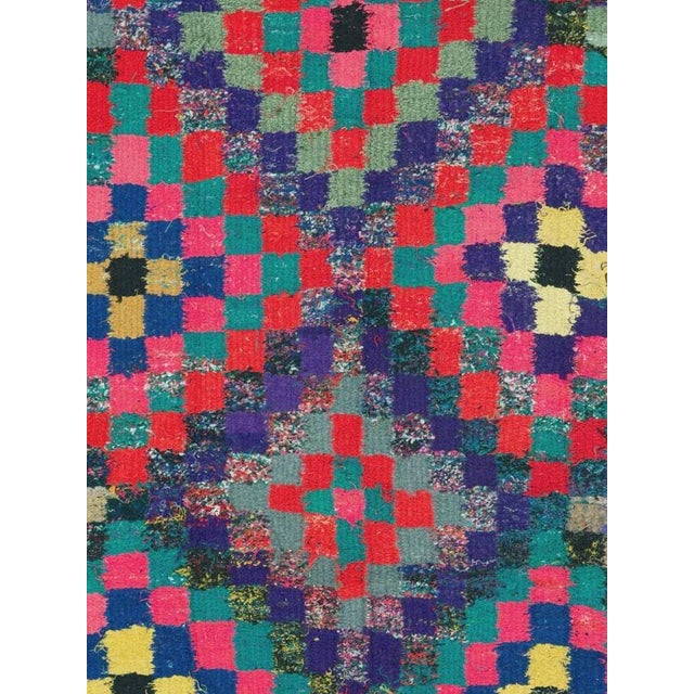 A vintage Persian flat-woven Kilim rug from the mid-20th century. A Kilim is a flat tapestry-woven carpet or rug...
