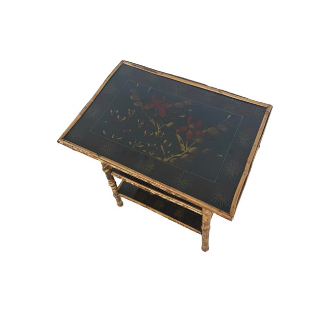 A distinctive antique Victorian Aesthetic Movement side table featuring a beautifully mottled tiger bamboo frame and three...