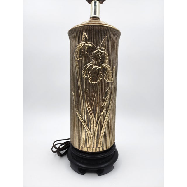 Illuminate your space with this elegant vintage brass table lamp featuring a beautifully detailed iris floral relief motif...