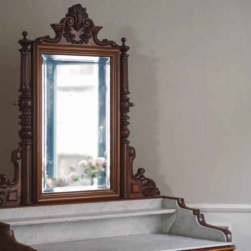 A stately mirrored chest of drawers from the gründerzeit period (circa 1880) with exquisite walnut grain, original mirror...