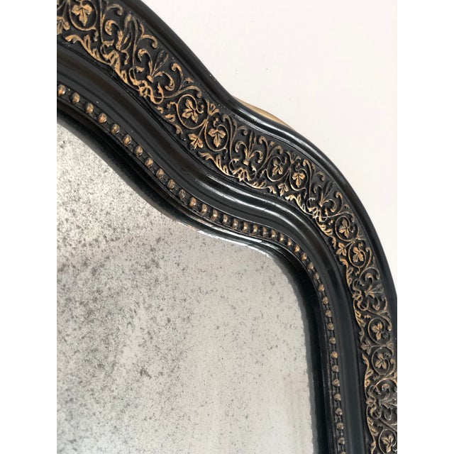 An elegant antique French Louis Philippe mirror, dating to the late 19th century. The full length mirror with mercury...