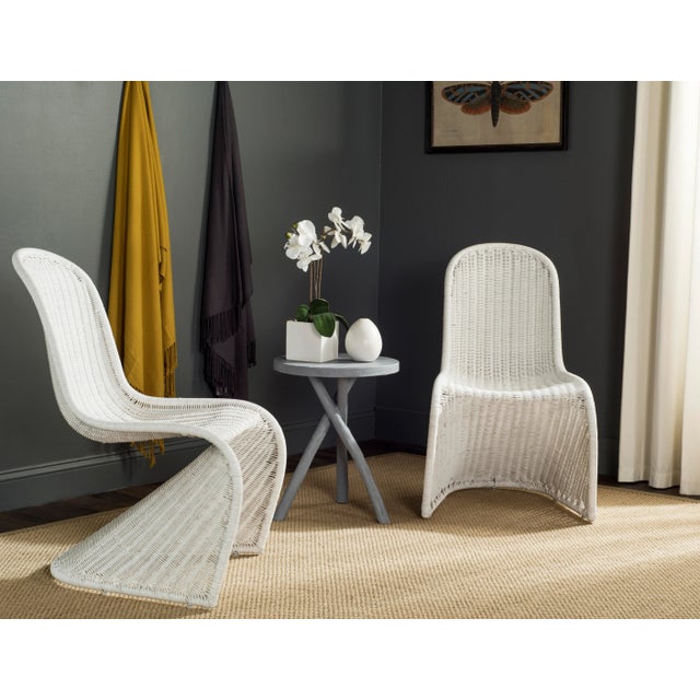 This contemporary wicker side chair is reminiscent of Verner Panton’s Danish design classics. Crafted in a neutral shade...