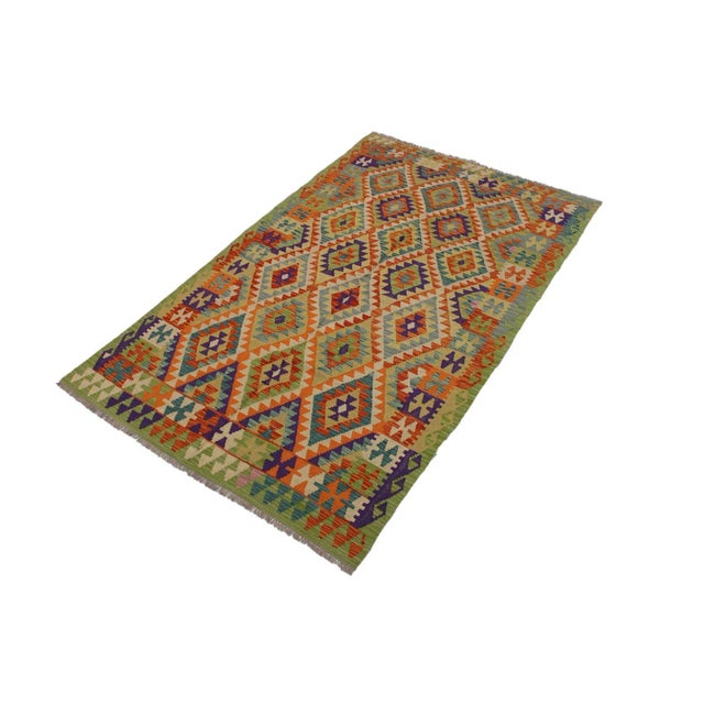 Add a touch of elegance to your home with this casual chic hand woven Tribal Kilim wool rug. Constructed on a loom by...