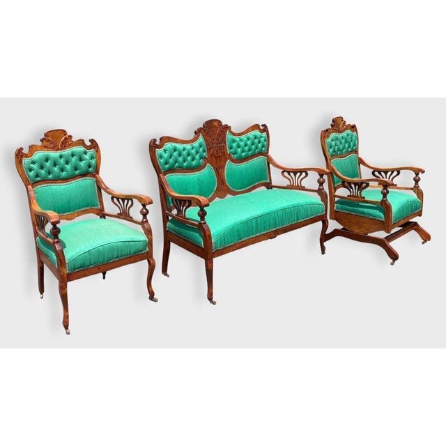 A wonderfully eccentric three-piece American walnut parlor suite dating to the turn of the 20th century, pairing...