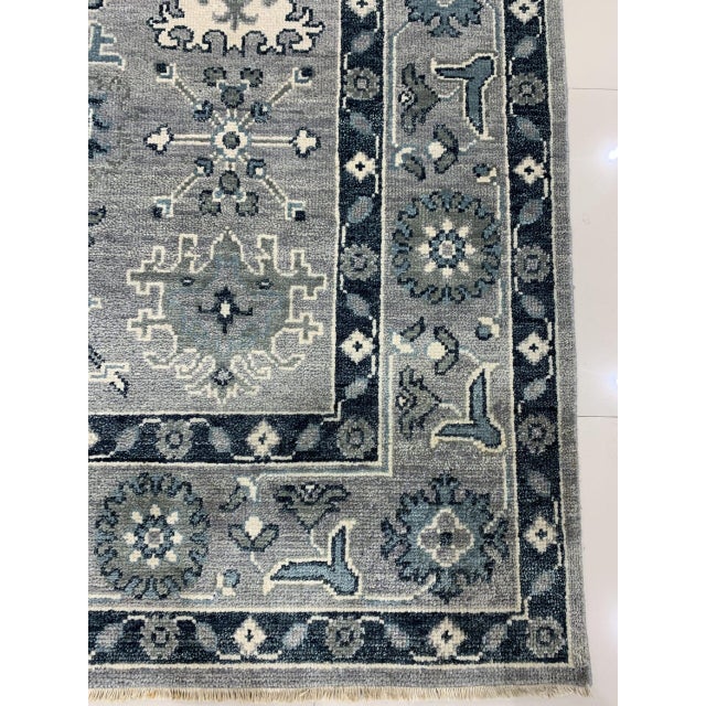 Maya Oushak Silver Hand Knotted Wool Rug, Country of Origin: India. This exquisite piece revives the grand scale and...