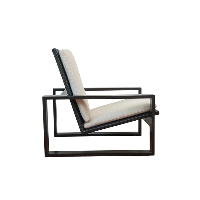 Modern open square armchair inspired by the Bauhaus Movement. Finishes available in blonde primavera wood with braided...