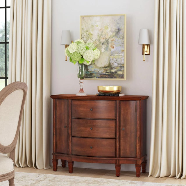 Offering abundant storage behind two doors and inside three dovetailed drawers, this spacious console cabinet is crafted...