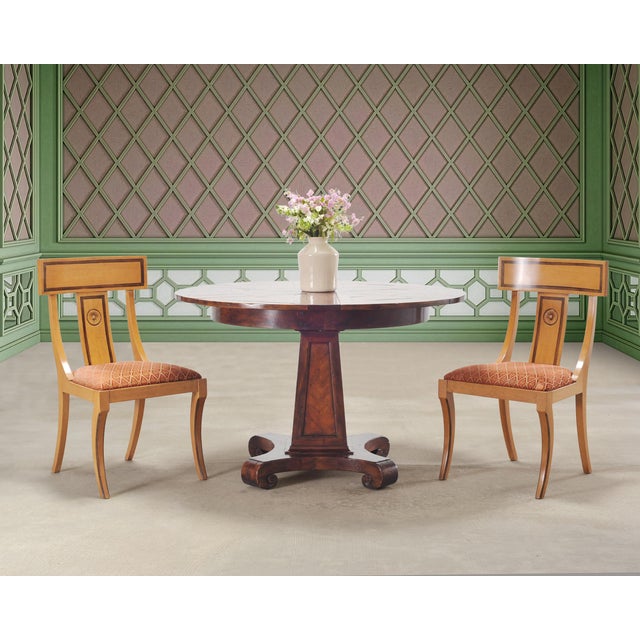 A handsome circular expanding pedestal "Castle Bromwich" jupe style dining table made by Theodore Alexander. Hand-crafted...