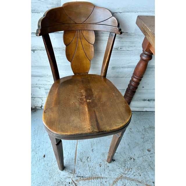 Antique kitchen table set. Solid oak table with three matching chairs. Carved backs on the chairs. Everything is very...