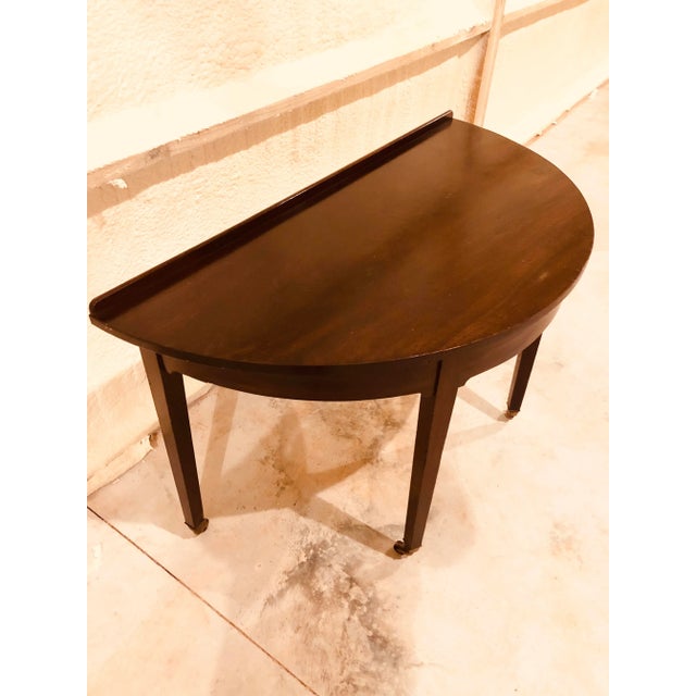 Fine George iii period mahogany demilune table with tapering square legs ending in brass cups with castors. Impressive...