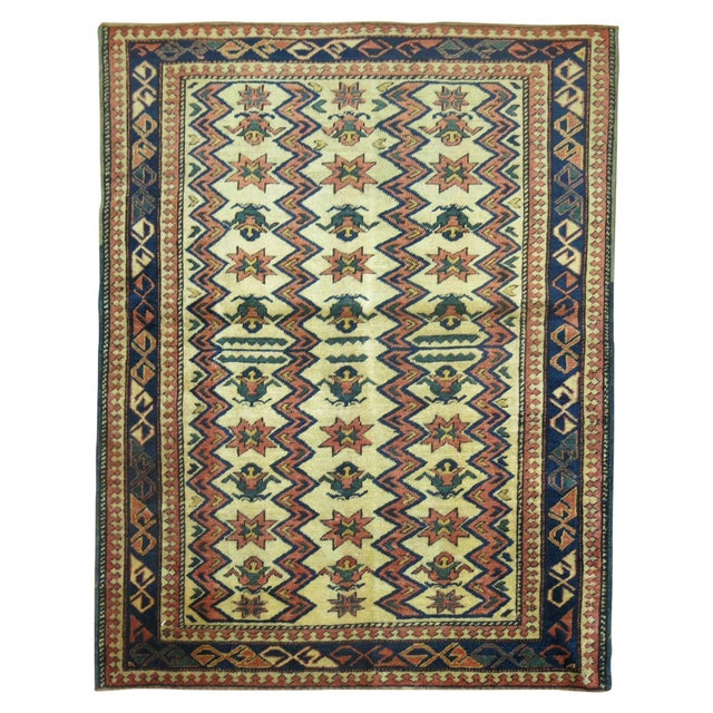 A square size antique Caucasian Shirvan rug from the 20th century. Olive green, rust, navy accents on a beige field....